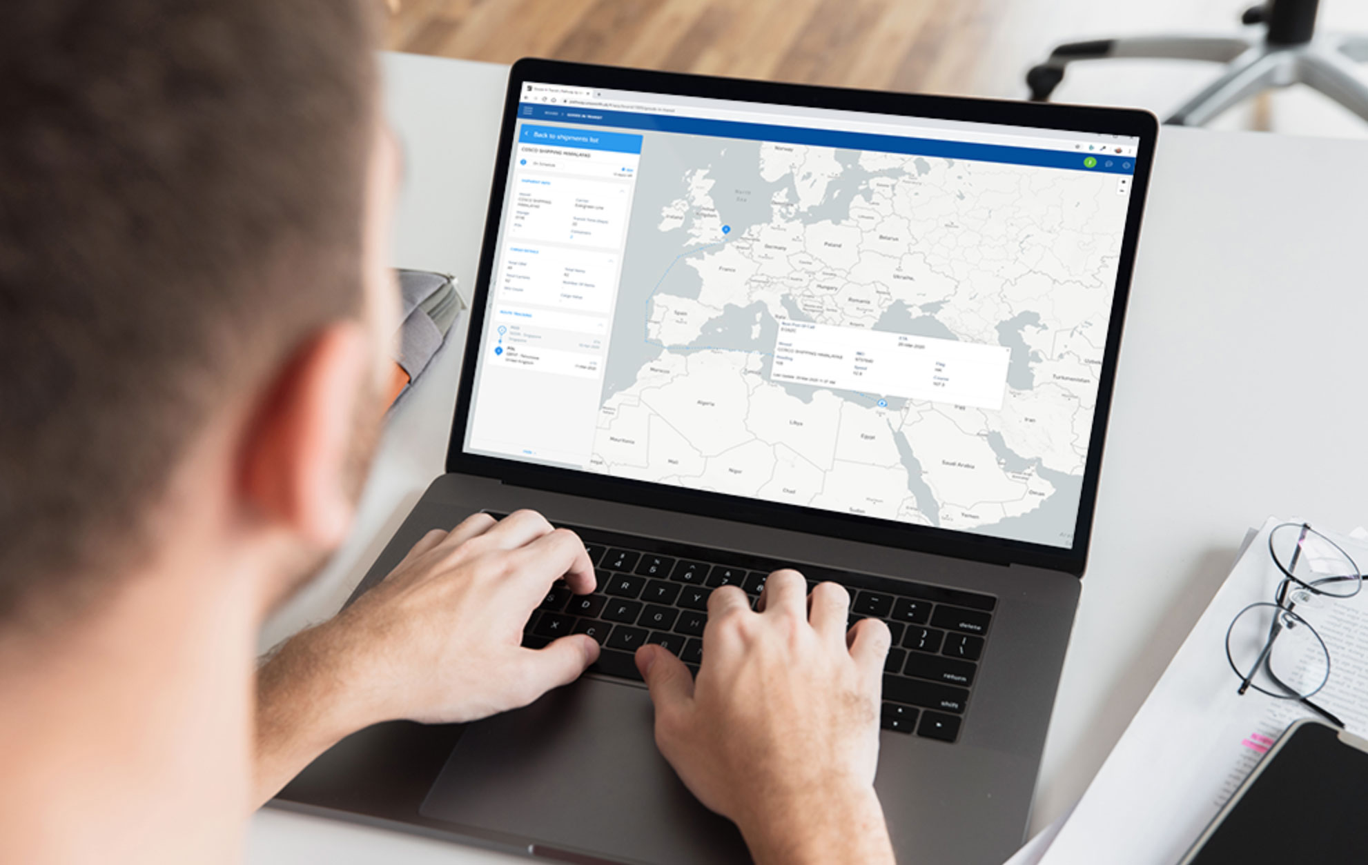 Man sitting at computer looking at his freight movement map