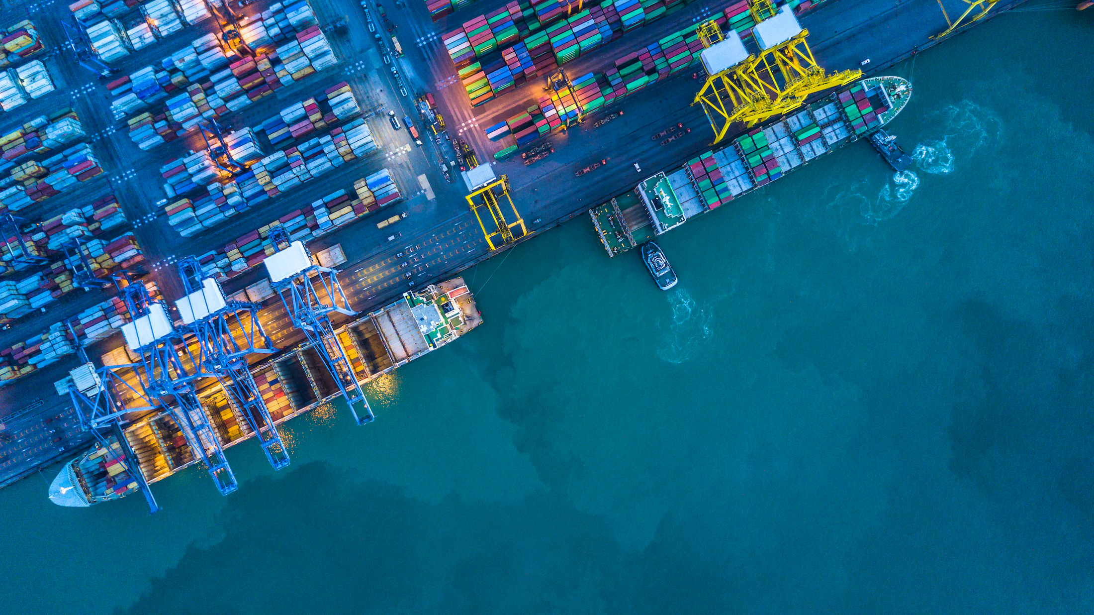 Shipping containers on dock surrounded by sea